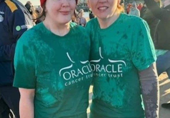 Caroline and Ann wearing Oracle TShirt wet, looking cold but happy at the beach